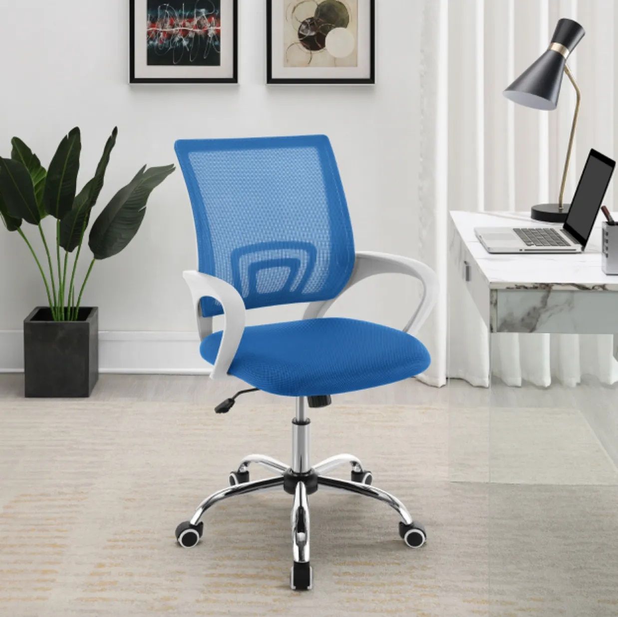 A blue office chair is sitting in front of a desk with a laptop on it