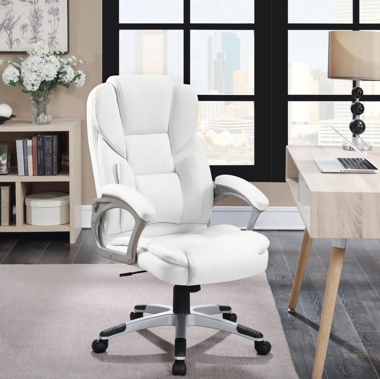A white office chair is sitting in front of a desk