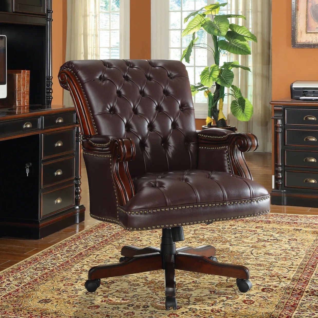A brown leather office chair is sitting on a rug in a room