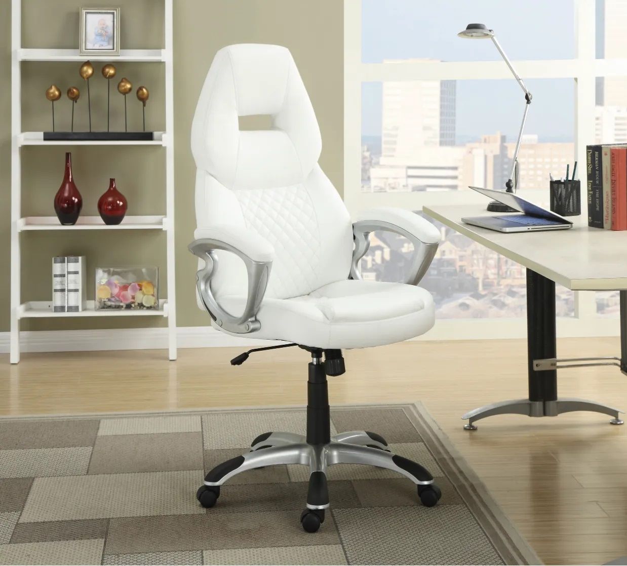 A white office chair sits in front of a desk