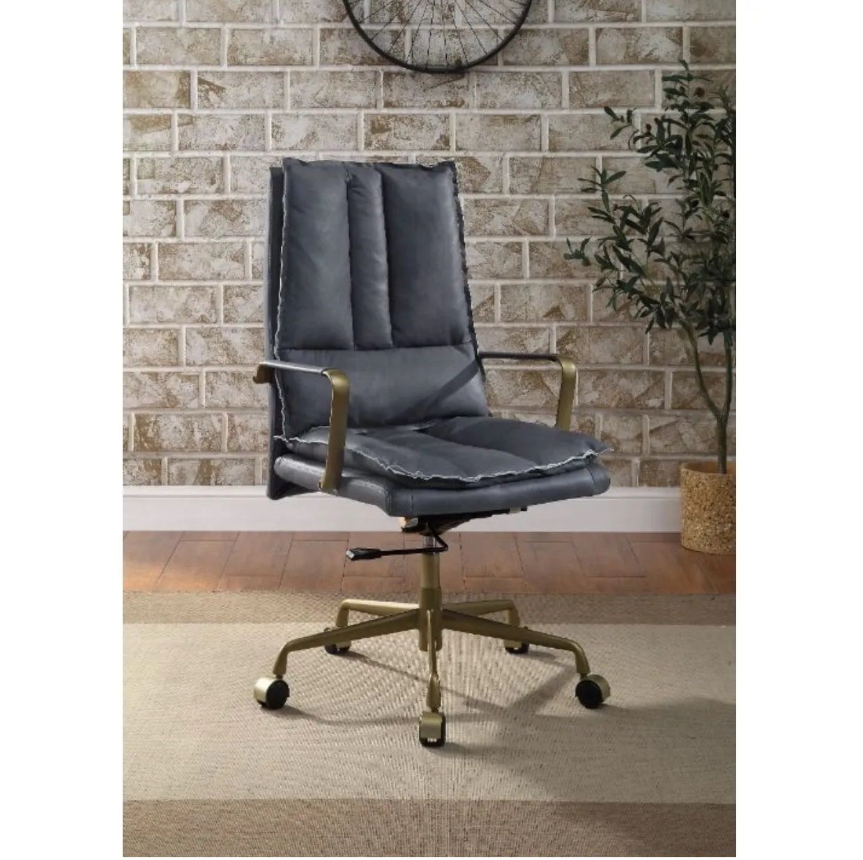 A black leather office chair is sitting on a rug in front of a brick wall.