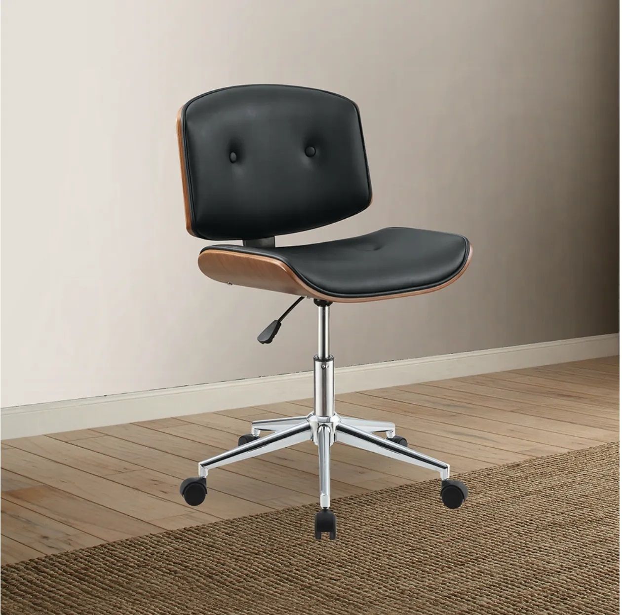 A black office chair is sitting on a wooden floor in a room.