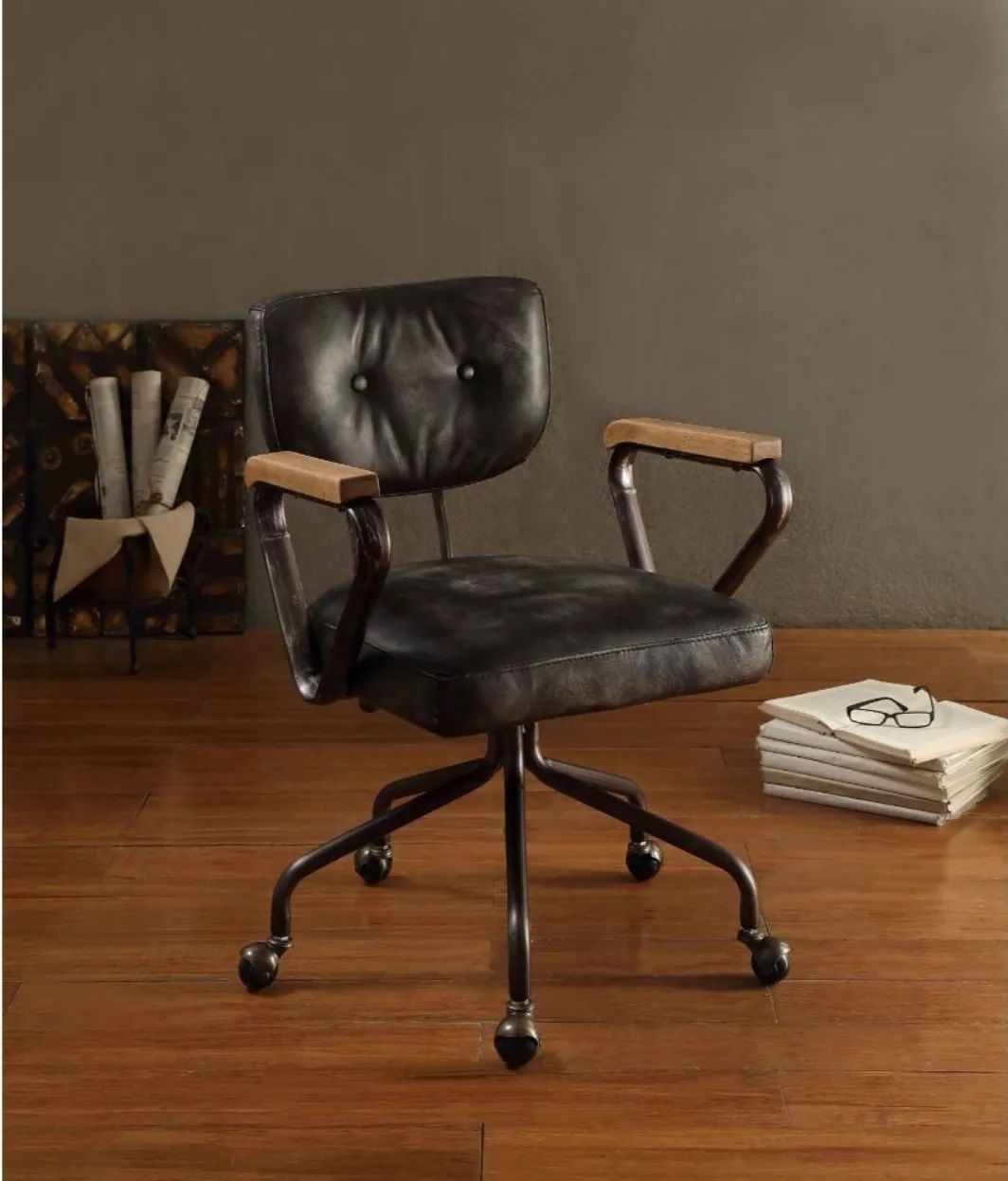 A black leather office chair with wooden arm rests