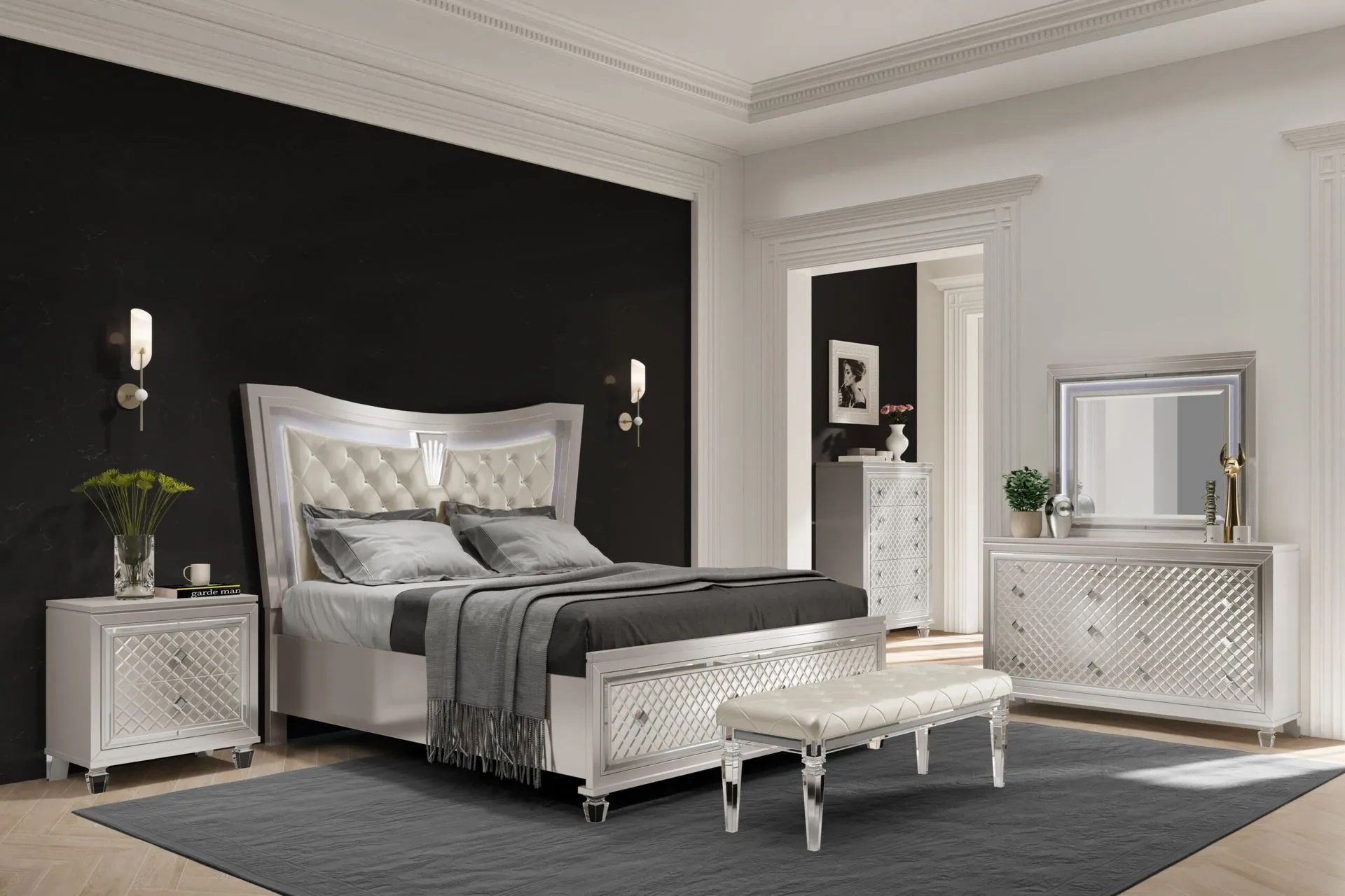 A bedroom with a bed , nightstand , dresser , mirror and bench.