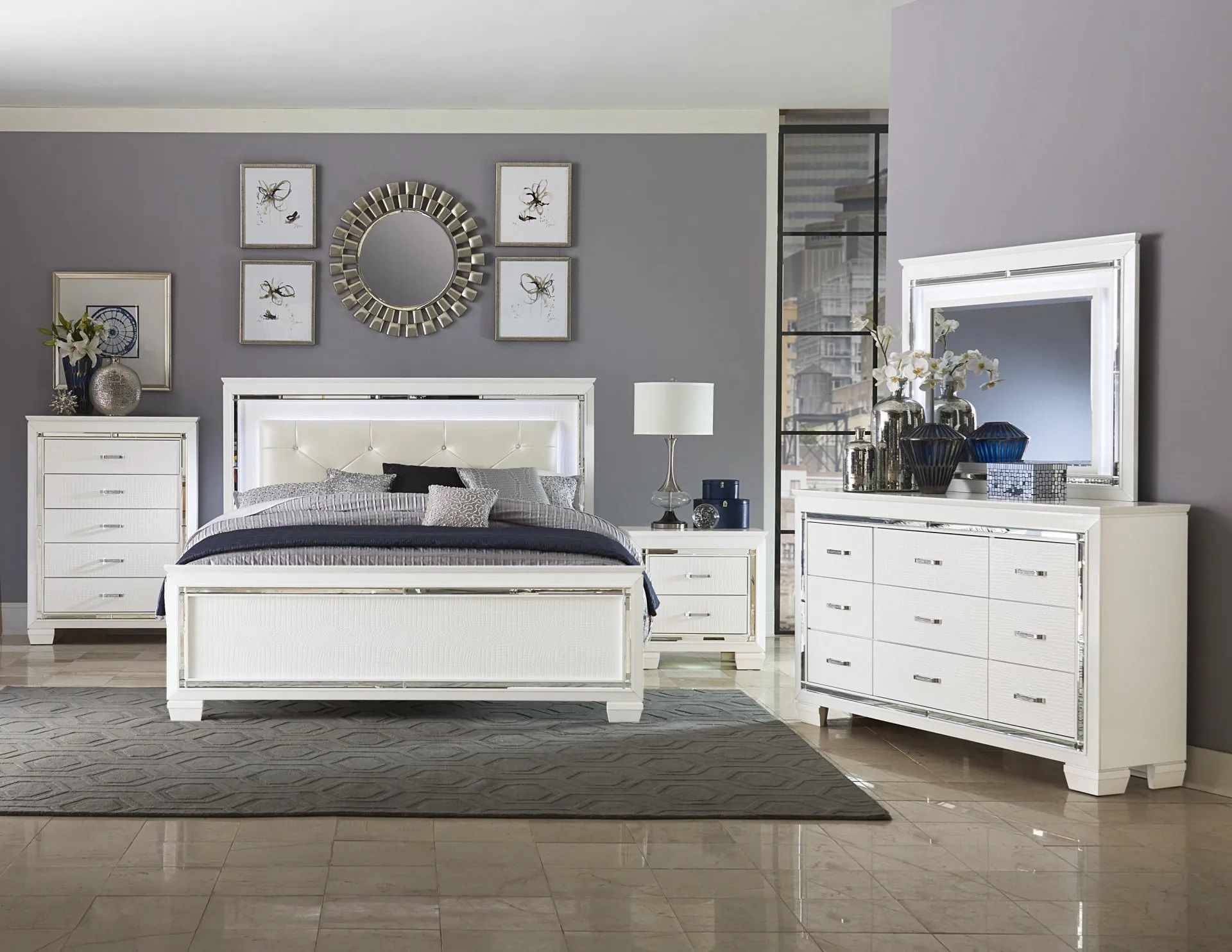 A bedroom with a bed , dresser , nightstand and mirror