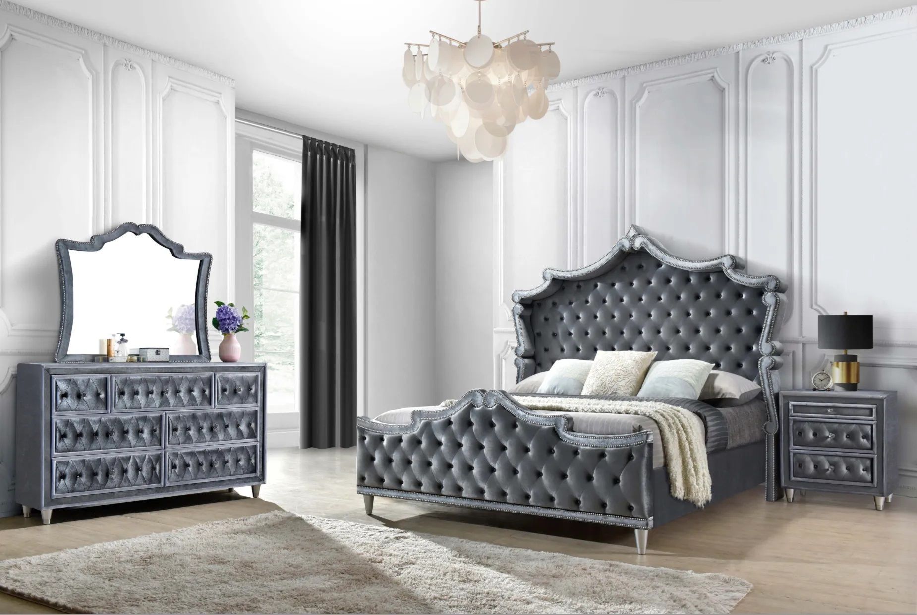 A bedroom with a bed , dresser , nightstand , mirror and rug.