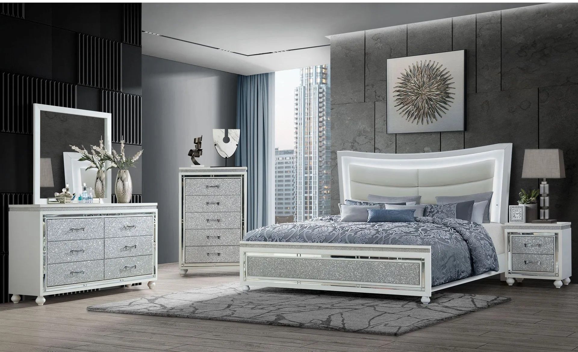 A bedroom with a bed , dresser , nightstand , mirror and rug.