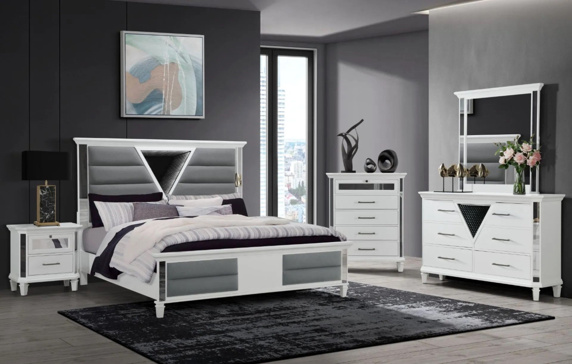 A bedroom with a bed , dresser , nightstand , mirror and rug.