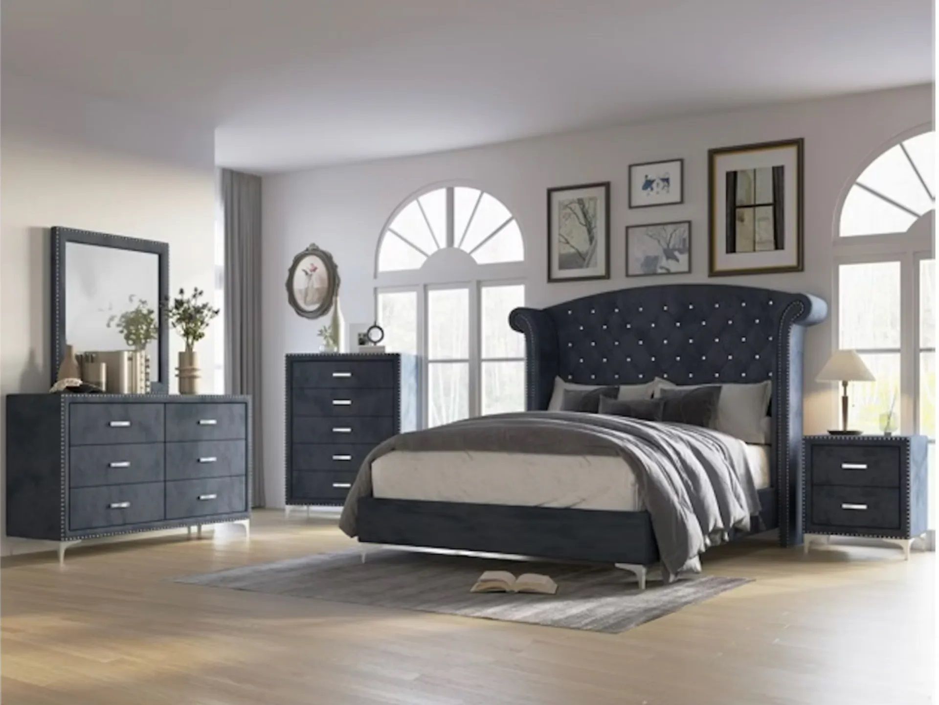 A bedroom with a bed , dresser , nightstand and mirror.