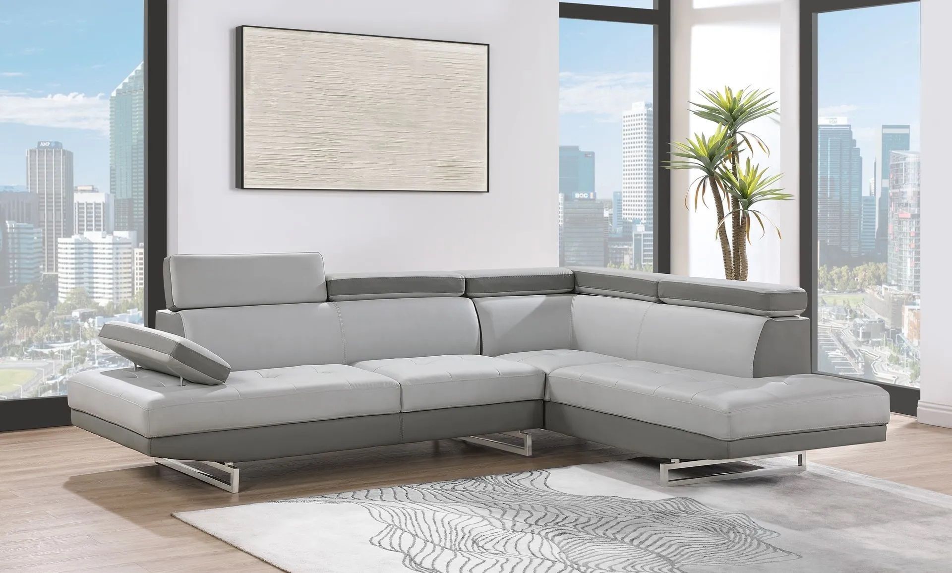 A living room with a large sectional couch and a painting on the wall.