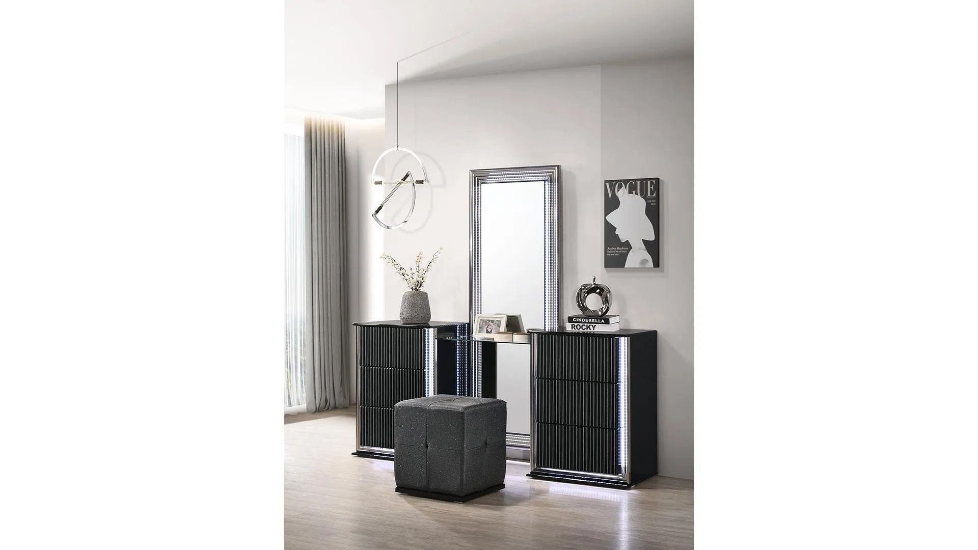 A bedroom with a dresser , mirror and ottoman.