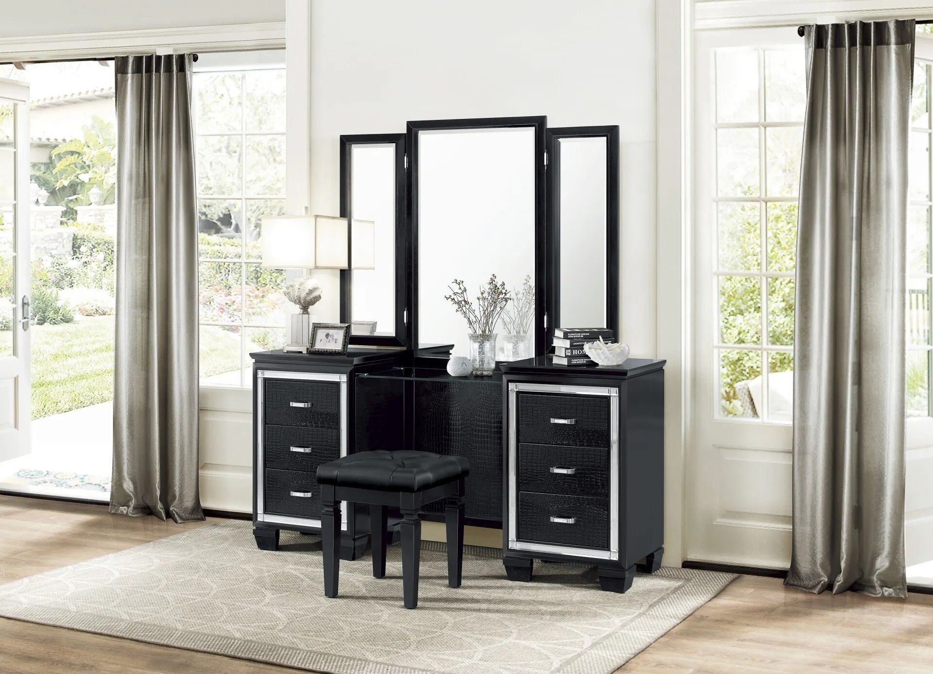 A bedroom with a vanity , mirror and stool.