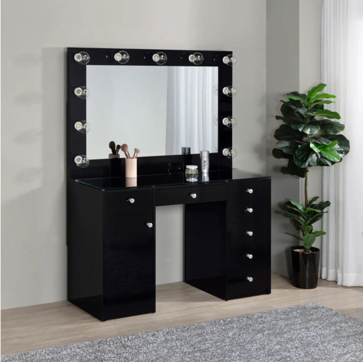 A black vanity with a mirror and lights on it
