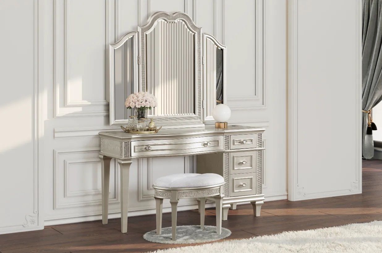 A vanity with a mirror and a stool in a bedroom.