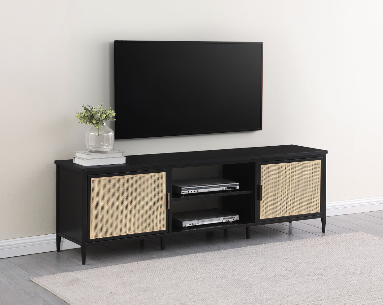 A flat screen tv is mounted on a wall above a black entertainment center.