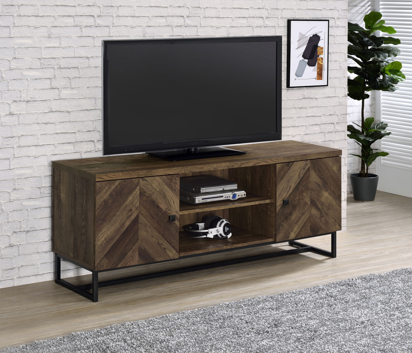 A flat screen tv is sitting on top of a wooden entertainment center in a living room.