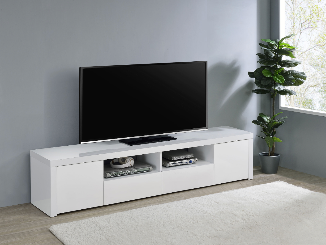A television is sitting on top of a white entertainment center in a living room.