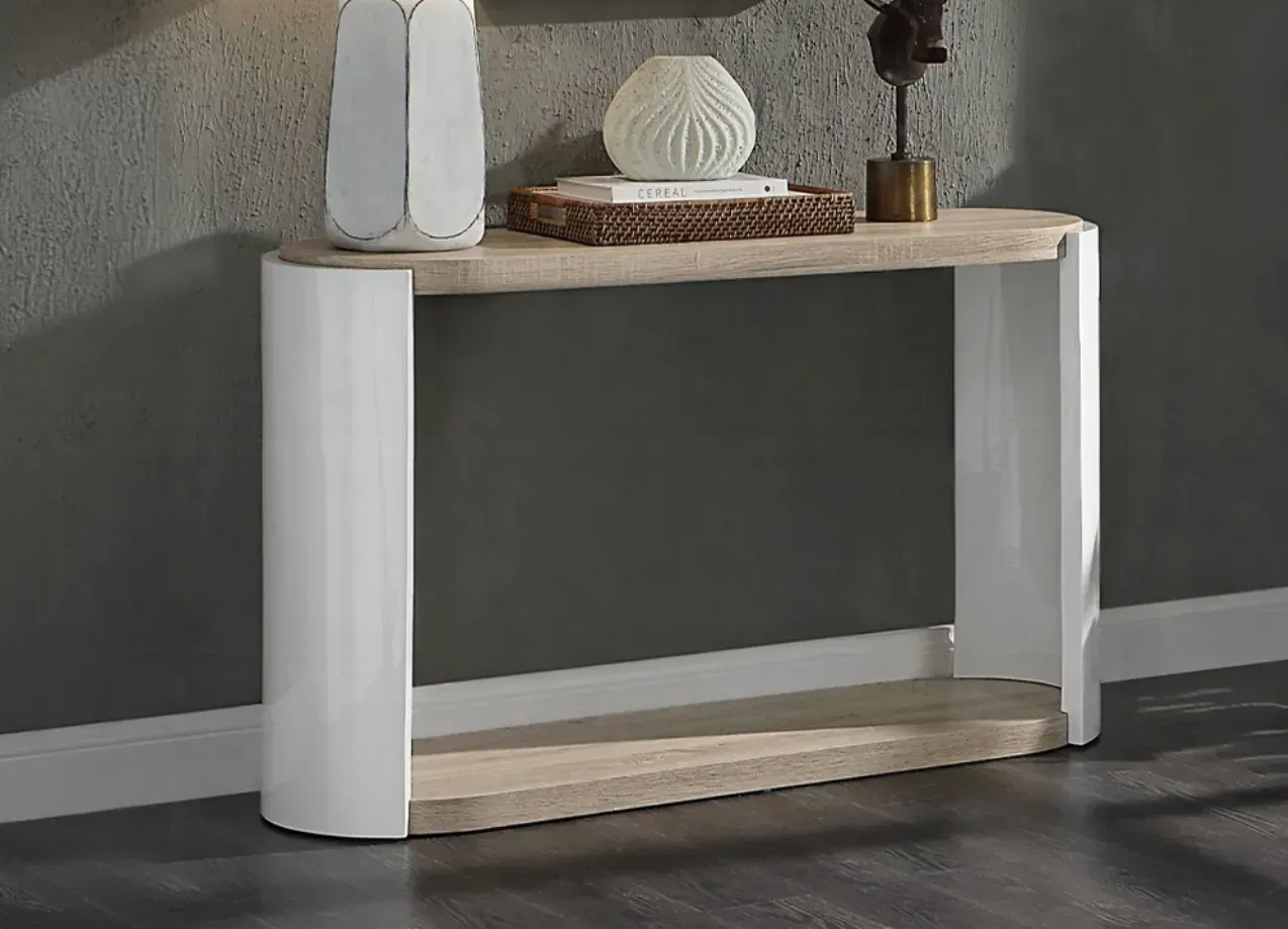 A white and wooden console table with a lamp on top of it.