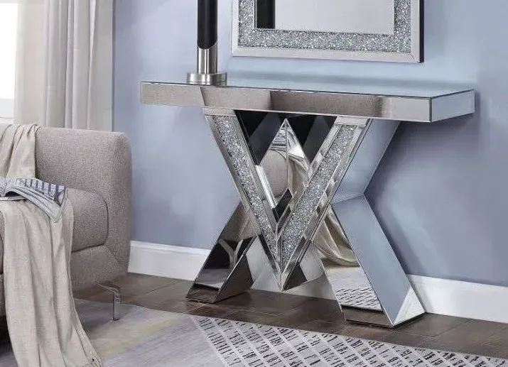 A living room with a mirror and a console table.