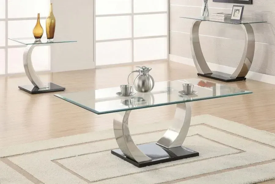 A living room with a glass coffee table and two side tables