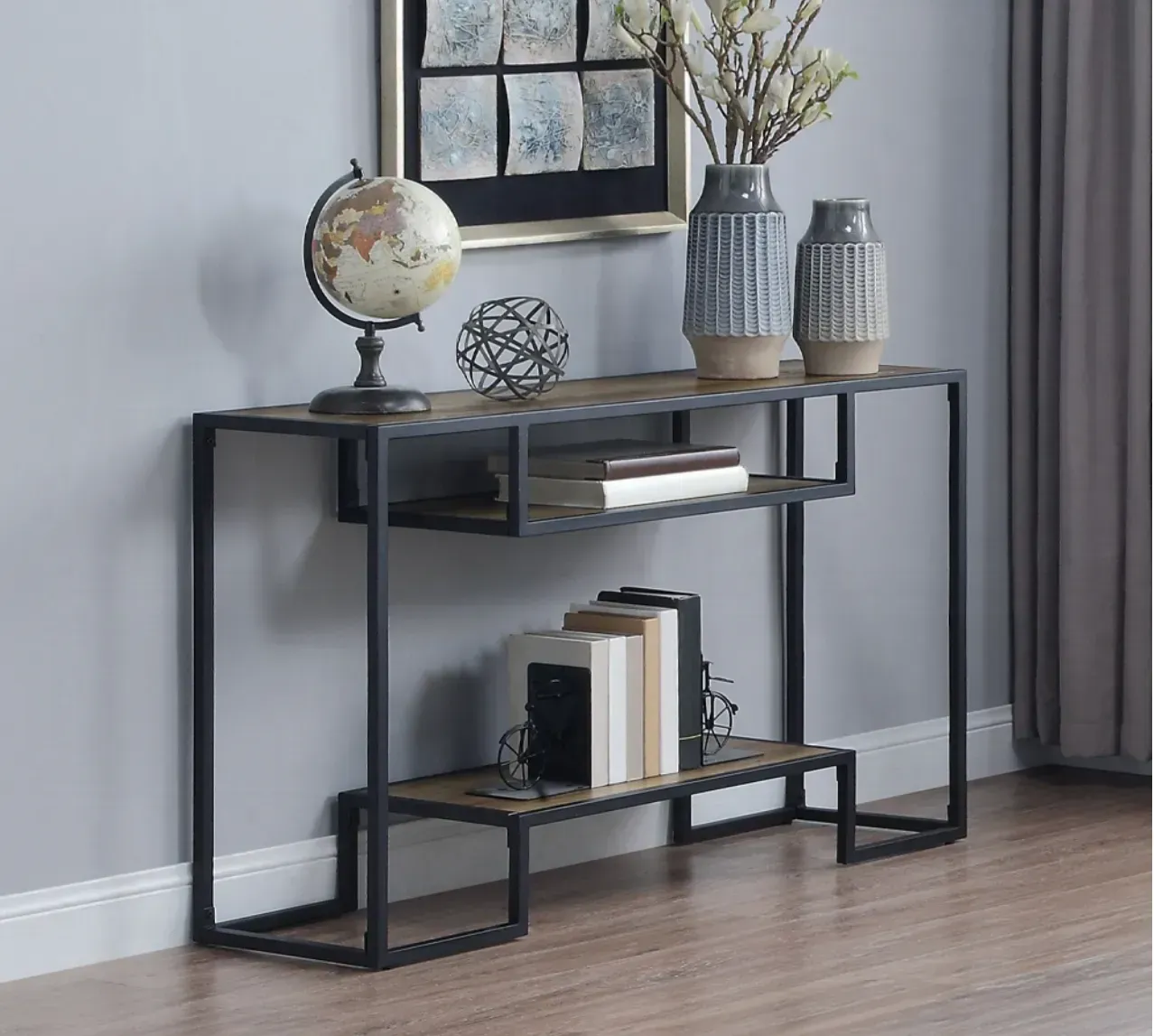 A console table with a globe and vases on it