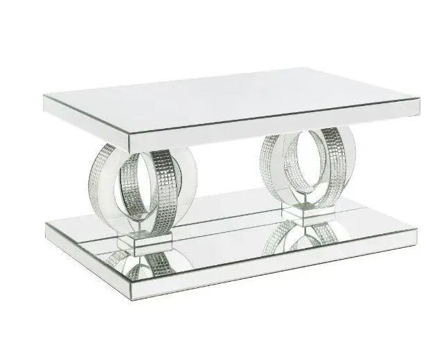 A mirrored coffee table with two circles on the base