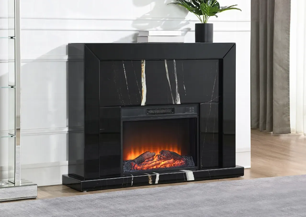 A black fireplace is sitting in a living room next to a plant.