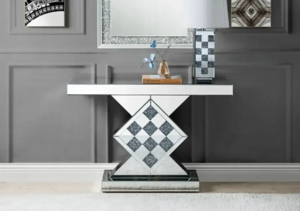 A hallway with a mirror and a table with a vase on it.