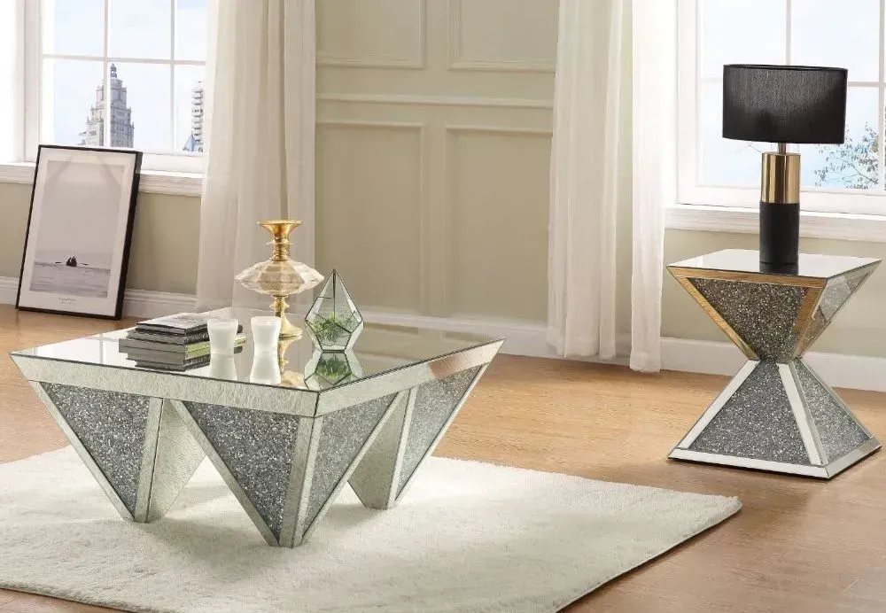 A living room with a coffee table and a lamp.