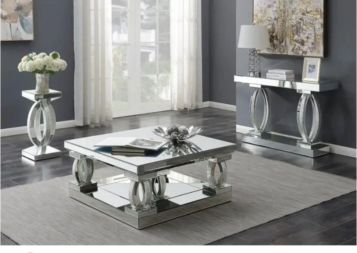 A living room with a coffee table and a console table.