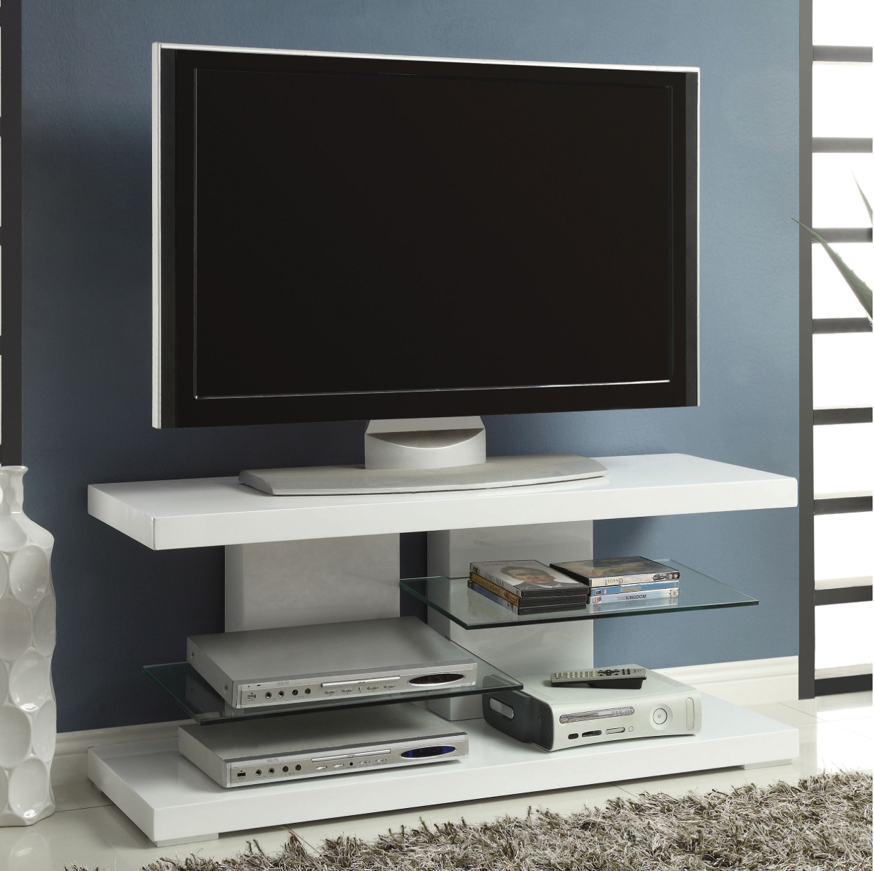 A flat screen tv sitting on top of a white entertainment center