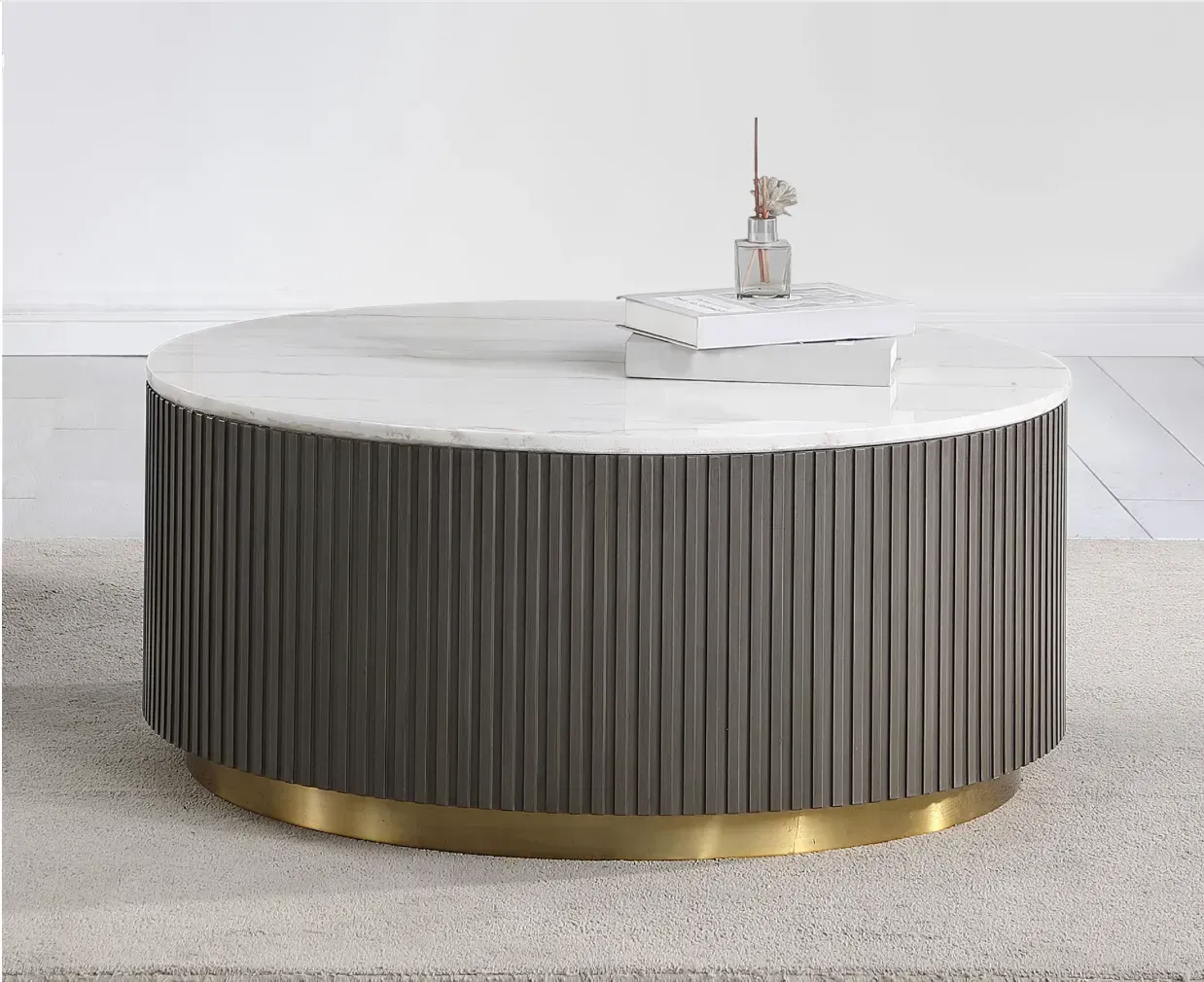 A round coffee table with a marble top and a vase on top of it.