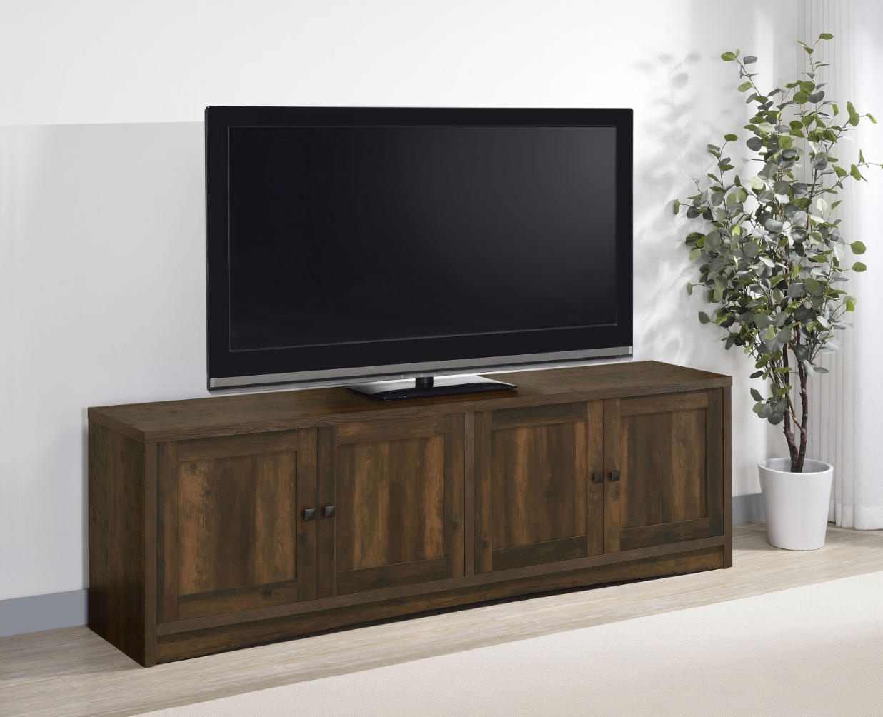 A flat screen tv is sitting on top of a wooden entertainment center.