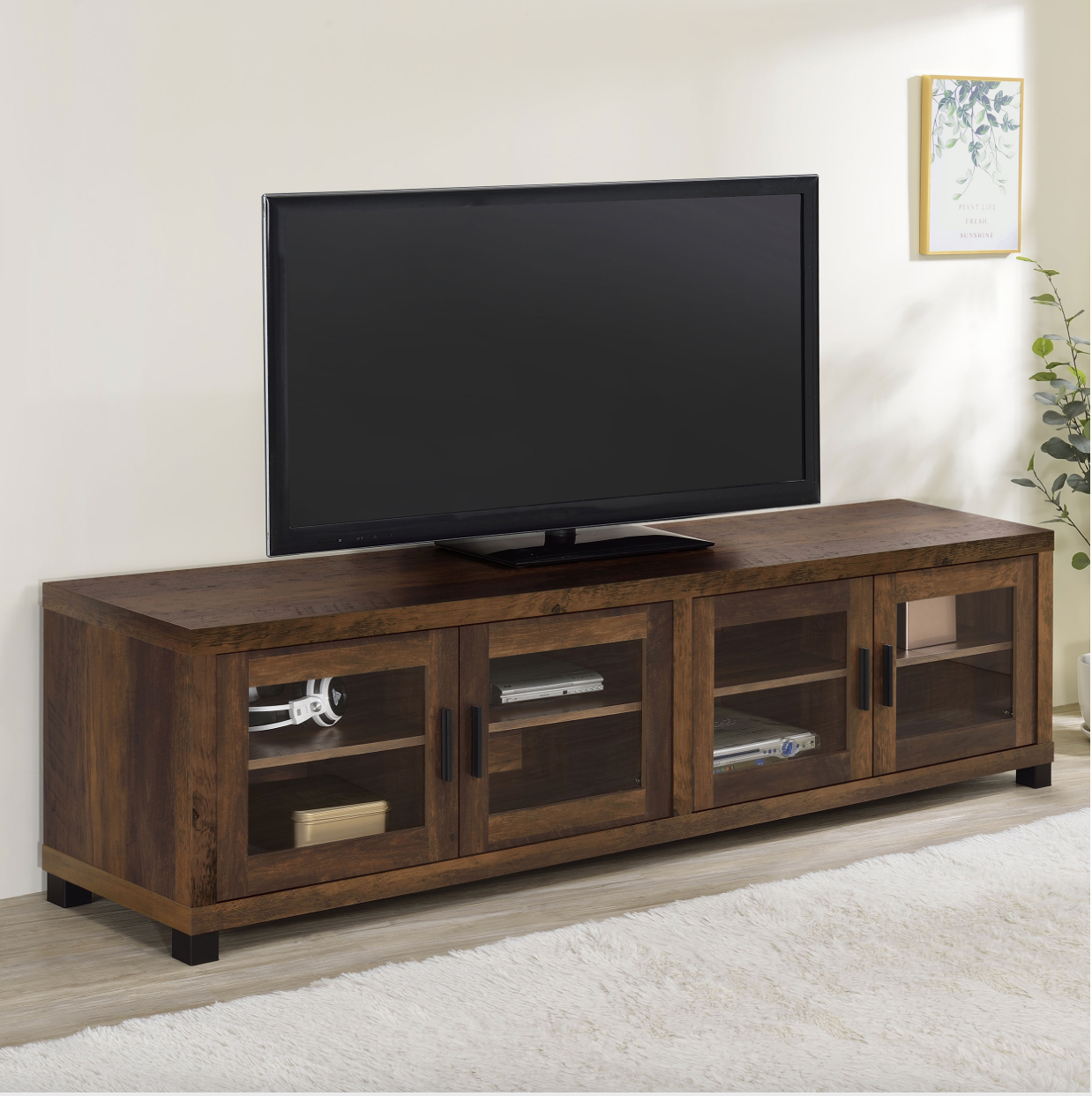 A flat screen tv is sitting on top of a wooden entertainment center