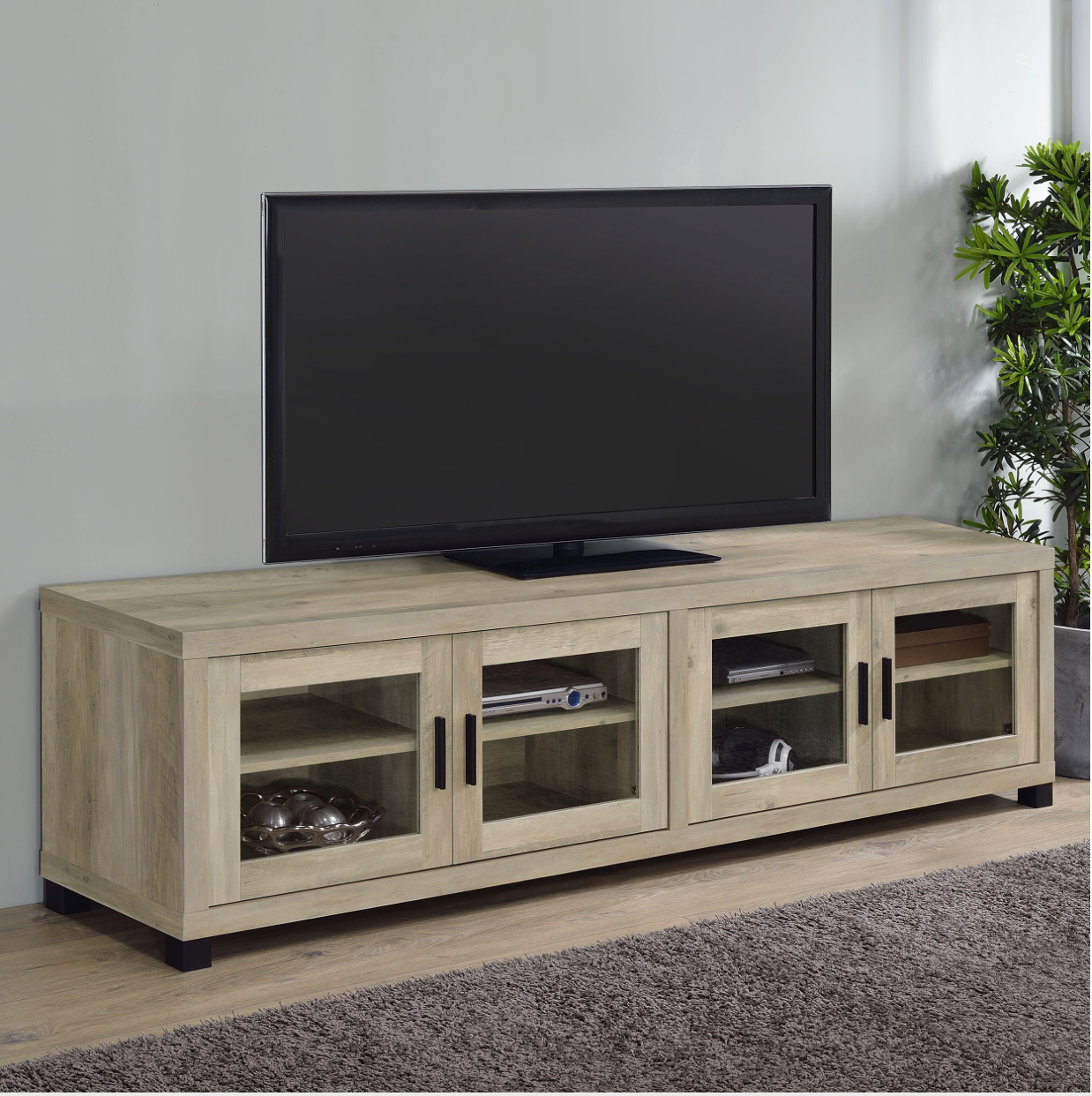 A flat screen tv is sitting on top of a wooden entertainment center.