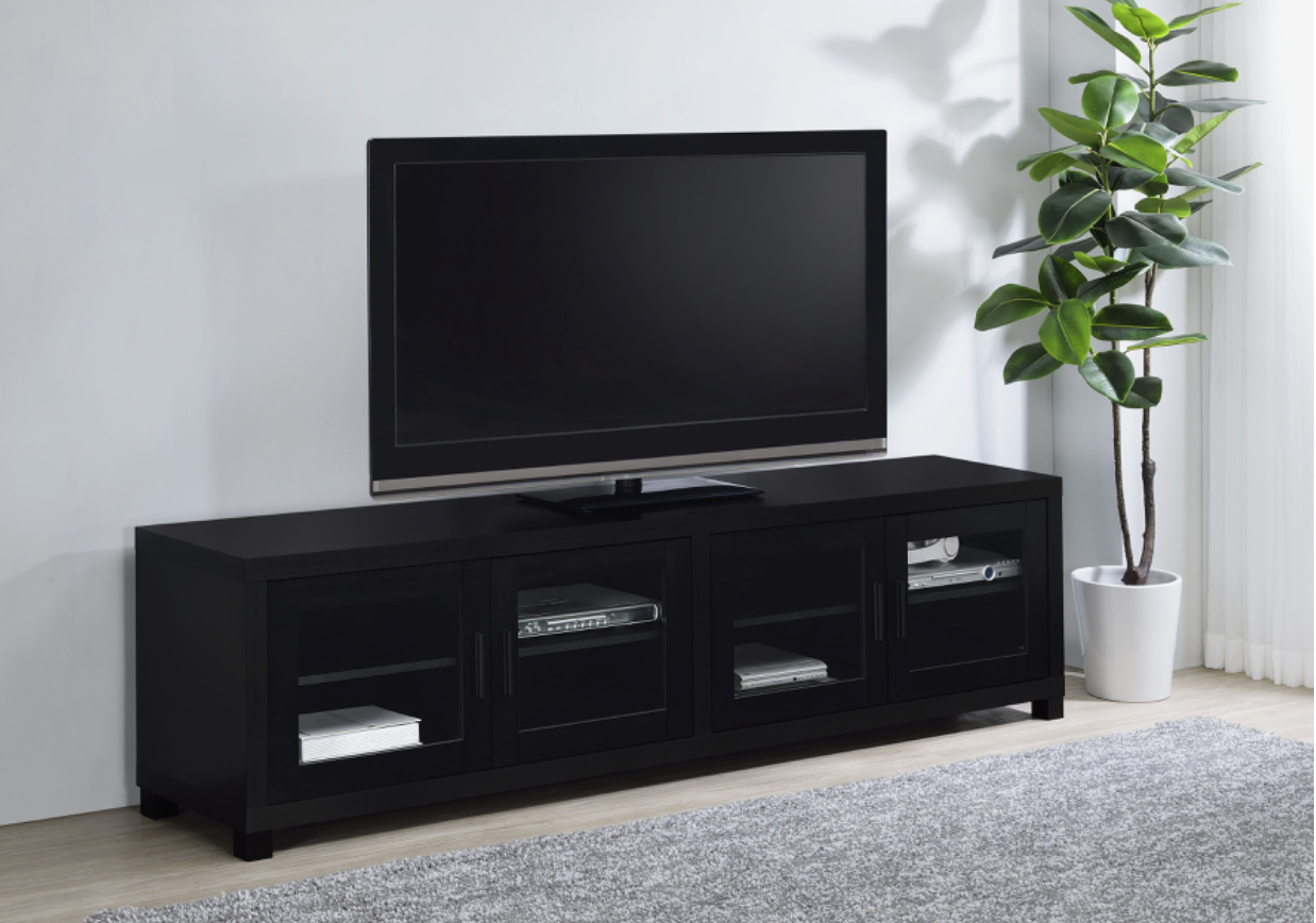 A flat screen tv is sitting on top of a black entertainment center.
