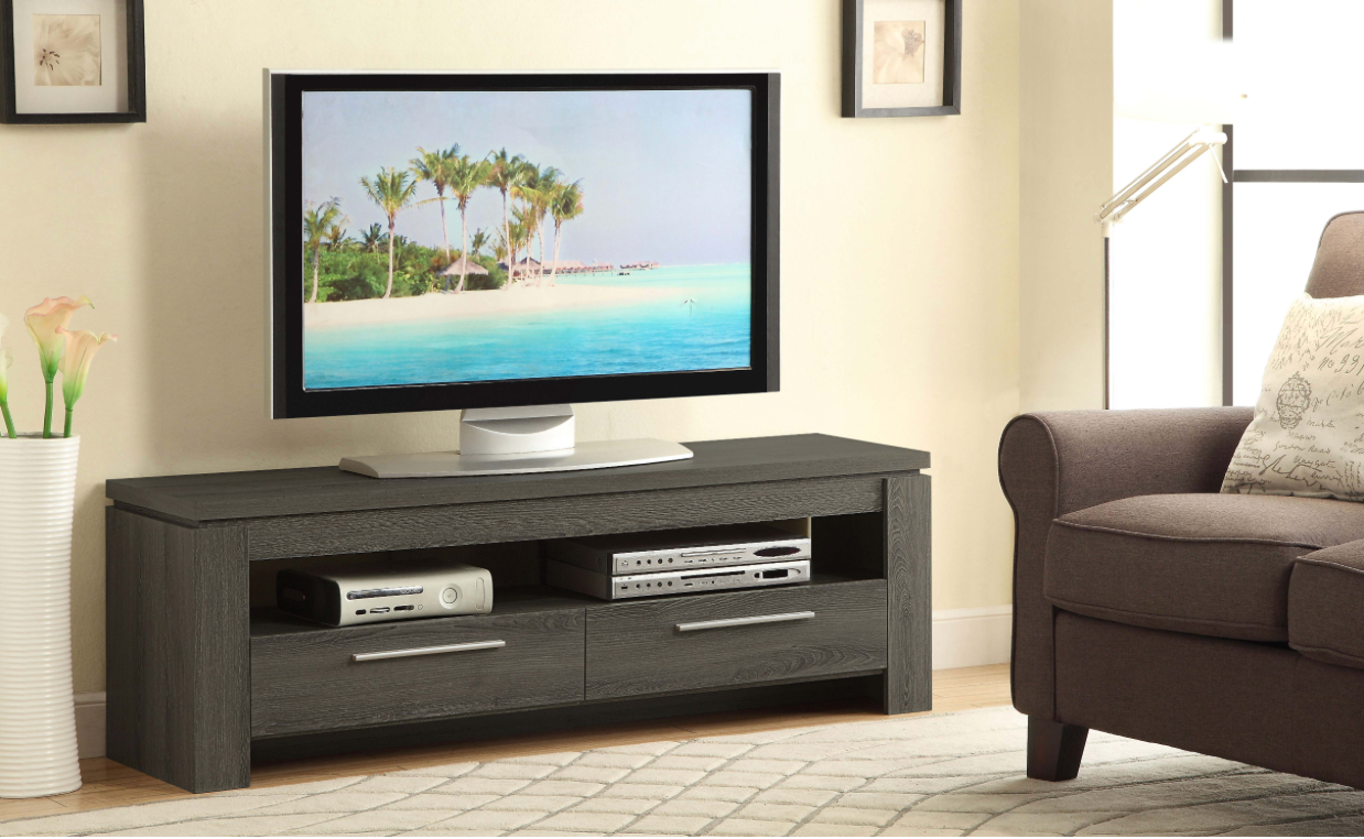 A living room with a tv on a stand and a chair