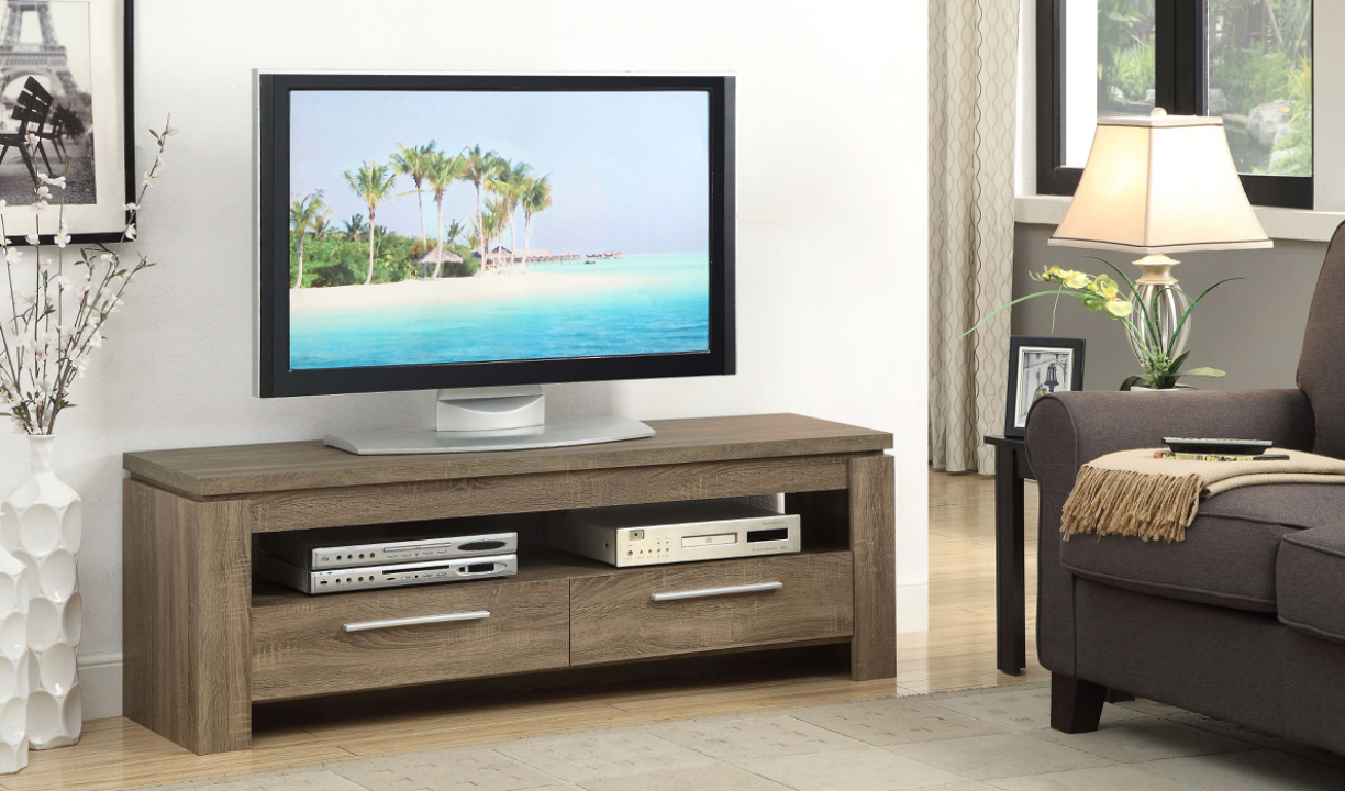 A flat screen tv is sitting on a wooden entertainment center in a living room.
