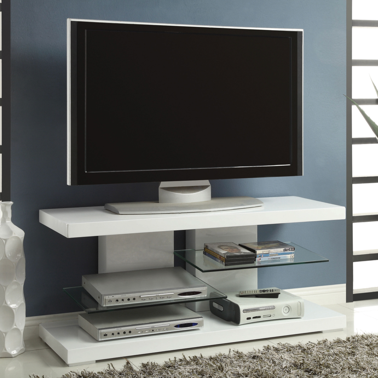 A flat screen tv is mounted on a white entertainment center