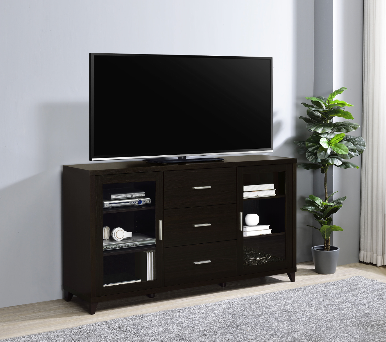A flat screen tv is sitting on top of a wooden entertainment center in a living room.