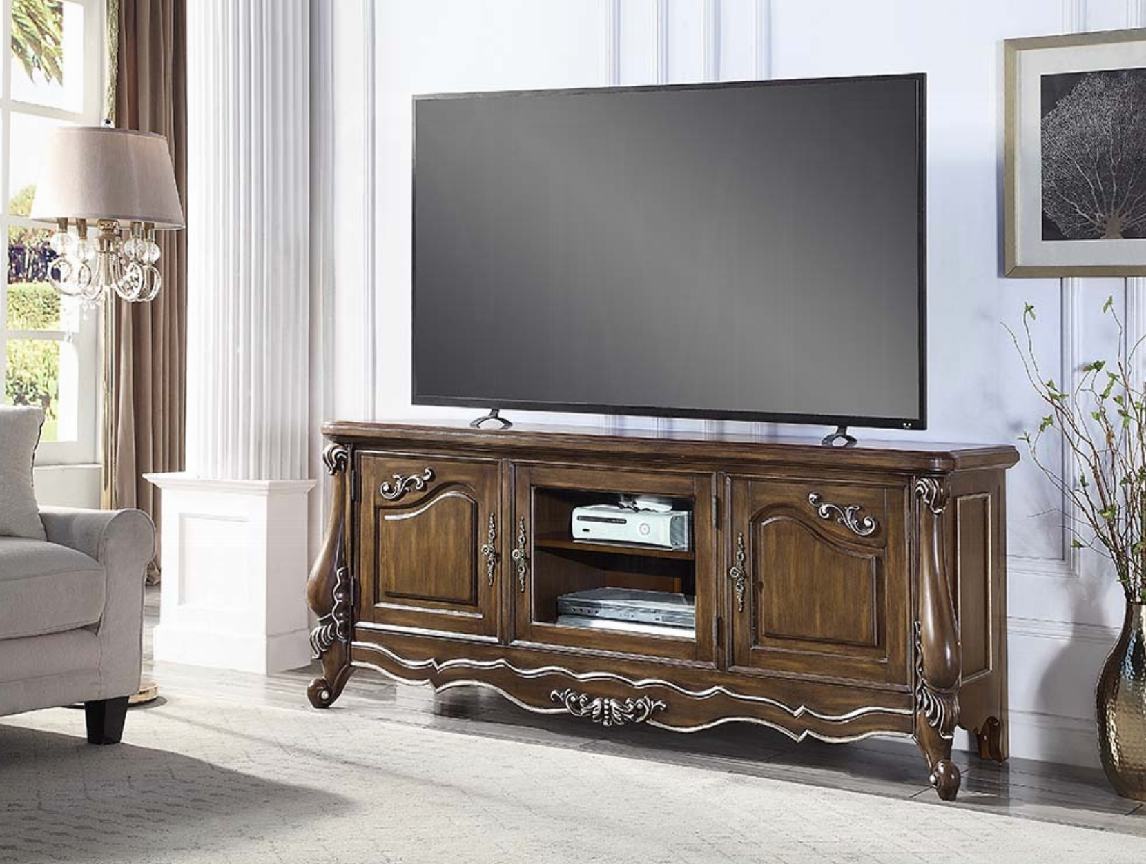 A flat screen tv is sitting on top of a wooden entertainment center in a living room.