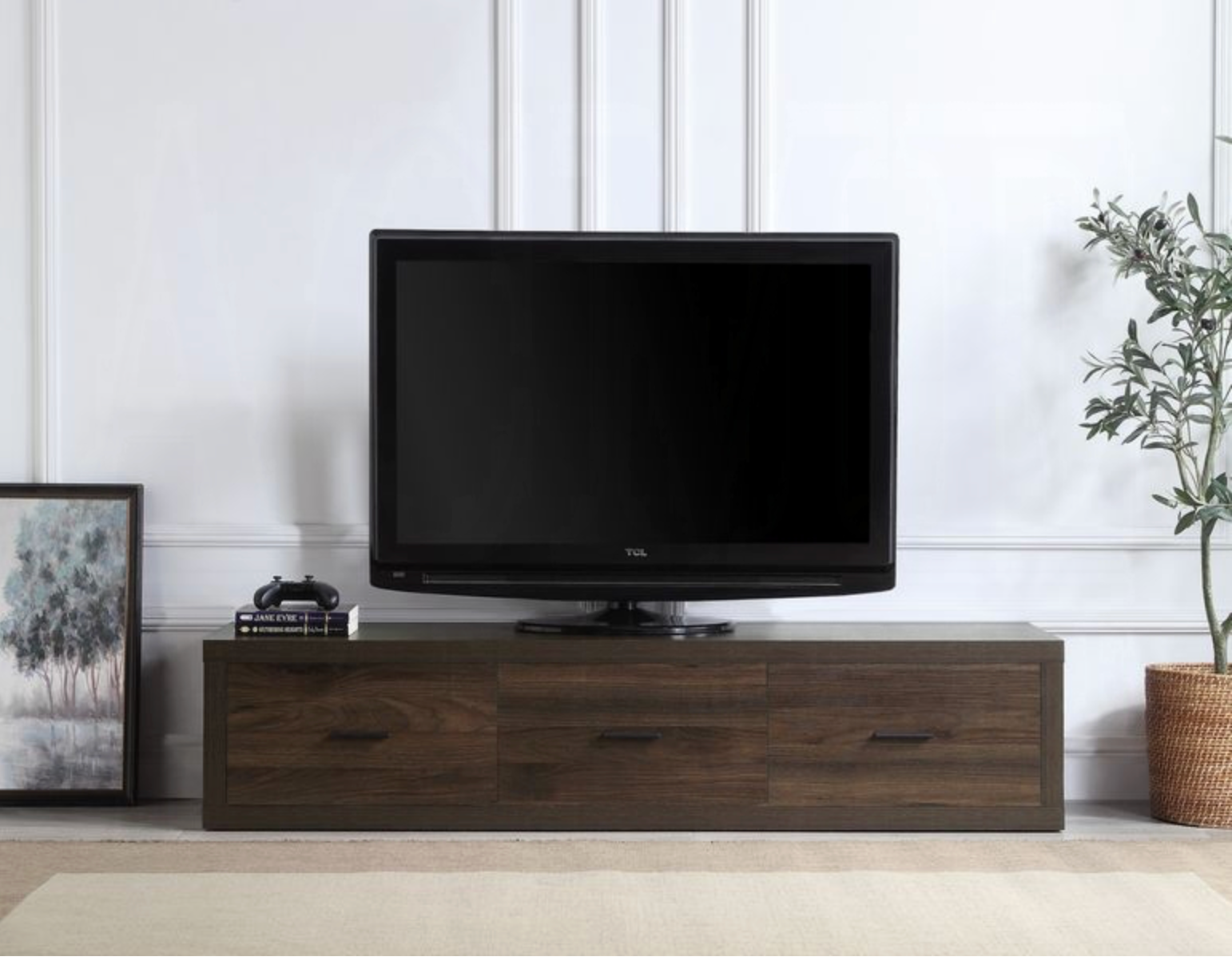 A flat screen tv is sitting on top of a wooden entertainment center.