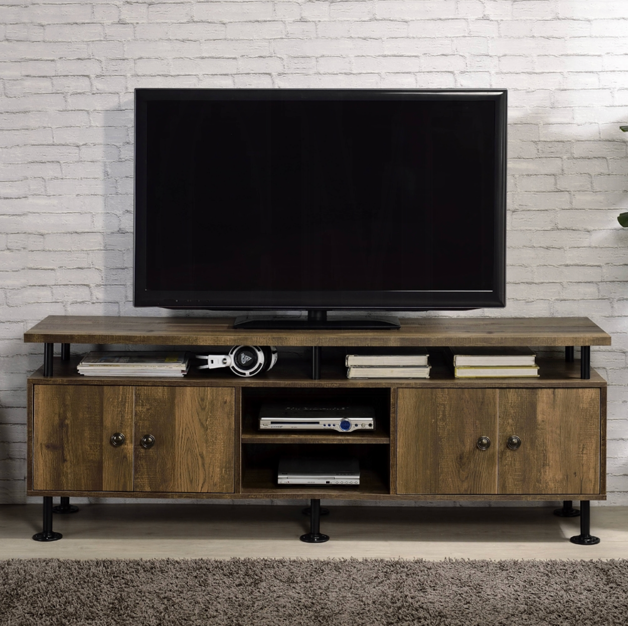 A flat screen tv is sitting on top of a wooden entertainment center