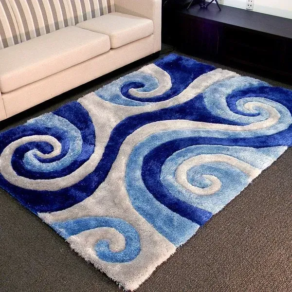 A blue and white rug in a living room next to a couch