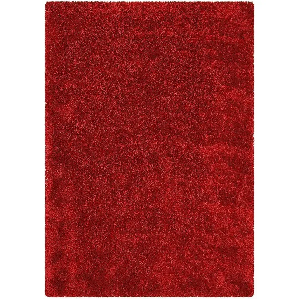A red rug is sitting on a white surface.