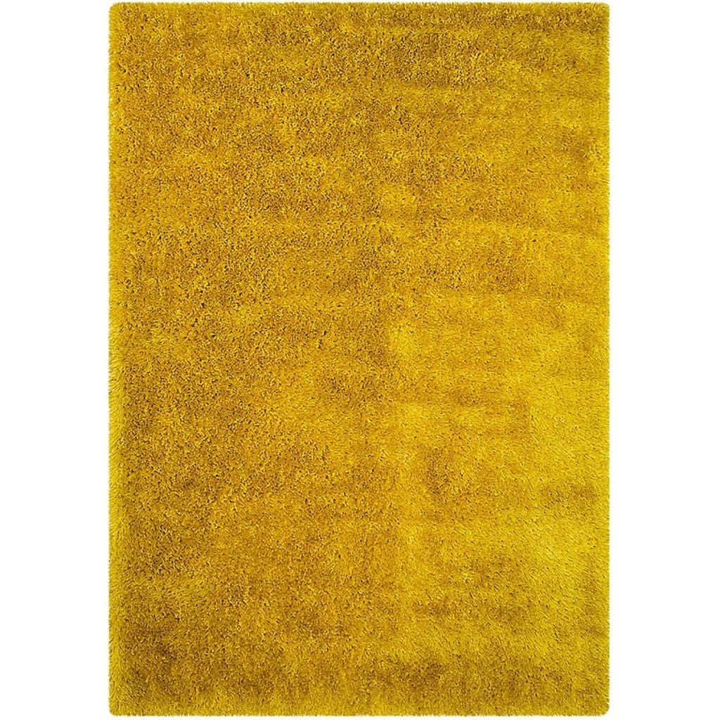 A yellow rug is sitting on a white surface.