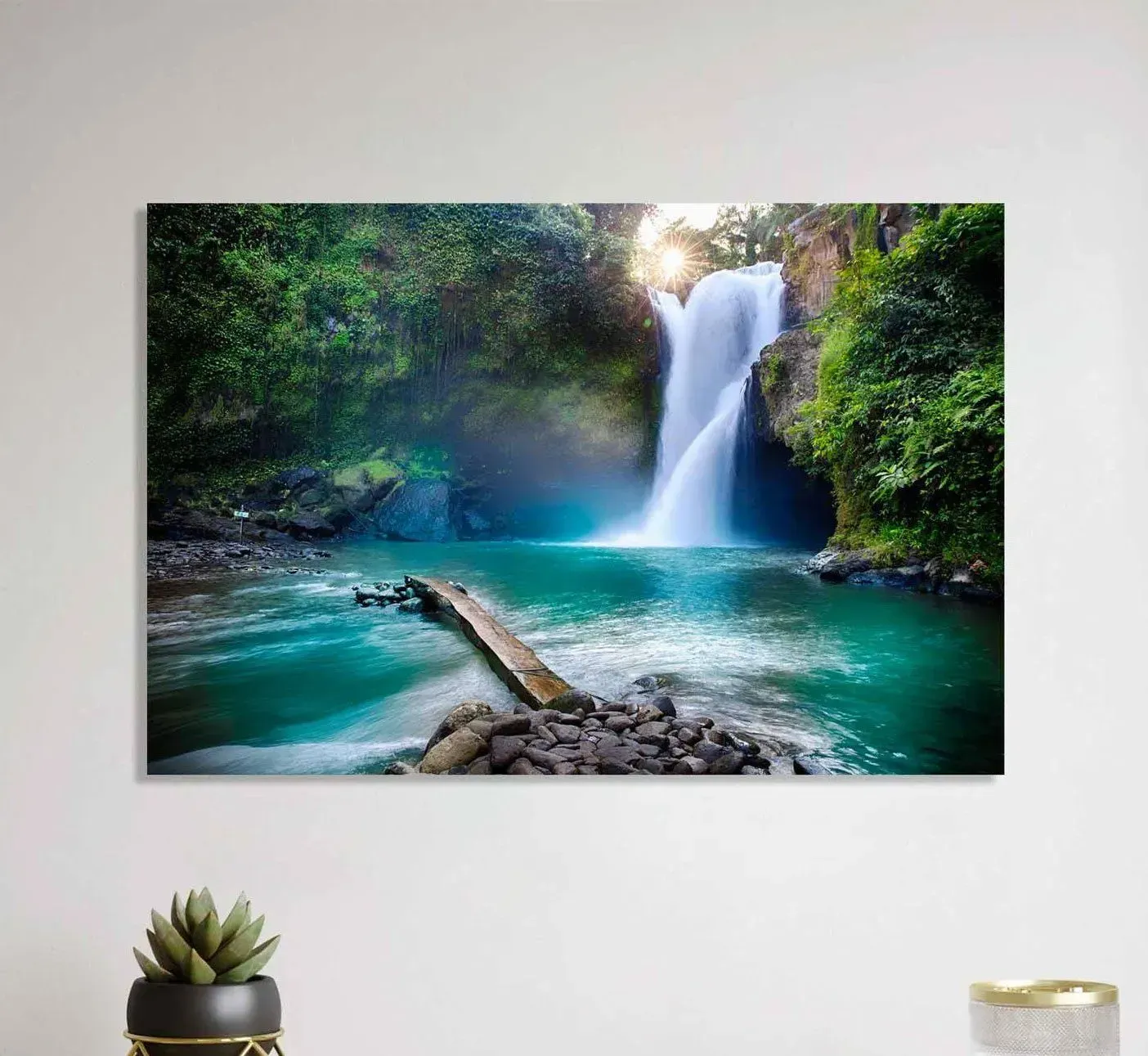 A painting of a waterfall in the middle of a forest on a wall.