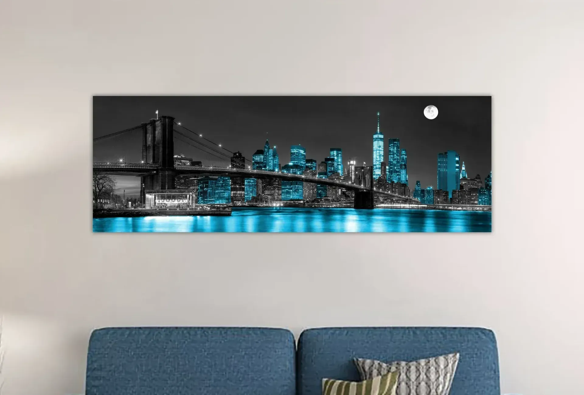 A living room with a couch and a painting on the wall.