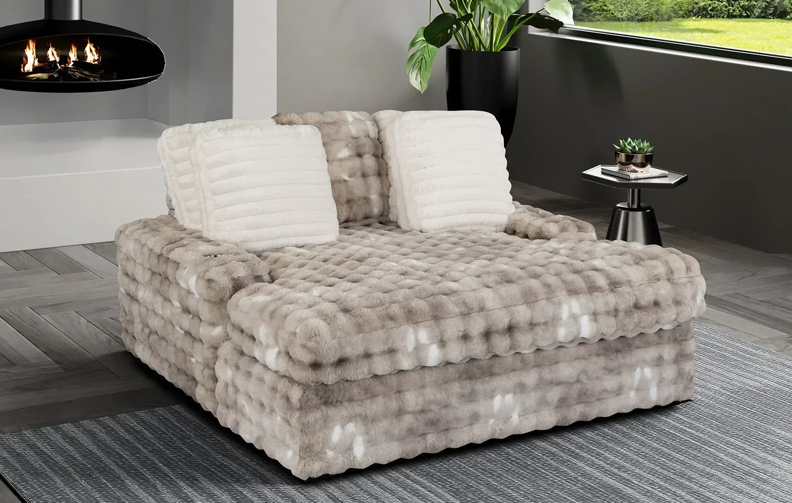 A large couch is sitting in a living room next to a fireplace.