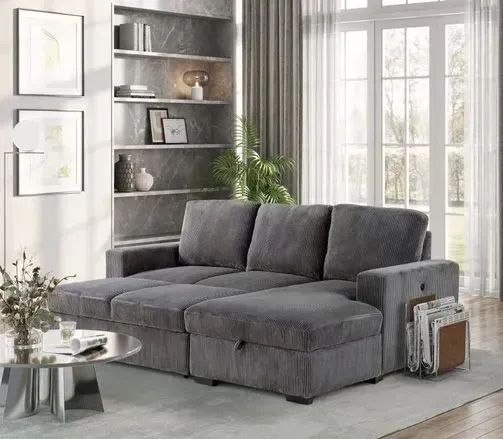 A living room with a gray sectional couch and a coffee table.